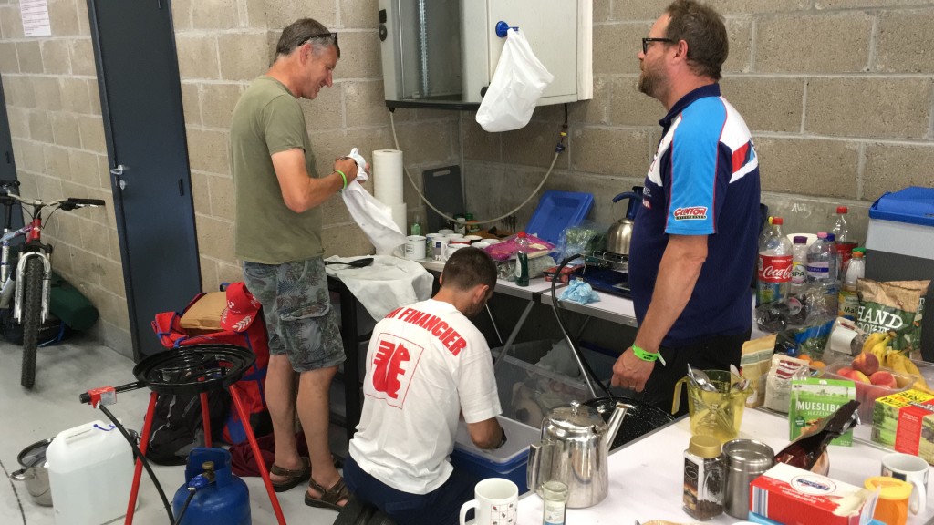 Peter Boast (left) and Guy Martin doing the washing up at the back of the pit garage. Jez (right) is telling them to get a move on